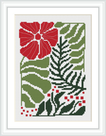 The image depicts a finished cross stitch pattern framed in white, featuring a large red poinsettia in the upper left corner, surrounded by various green leaves and smaller red accent flowers. The background is white and the design is prominent with its holiday-themed colors.