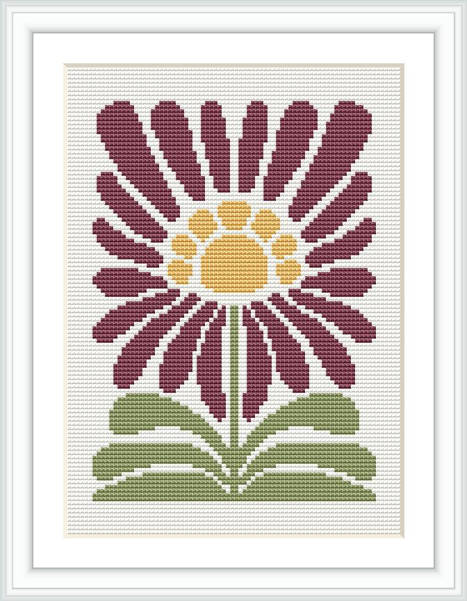 The image depicts a cross stitch pattern framed in white with a representation of a purple flower with yellow center against a white fabric. Leaves and stem are stitched in shades of green. The pattern is rendered in a pixel-like grid, typical for cross stitch techniques.