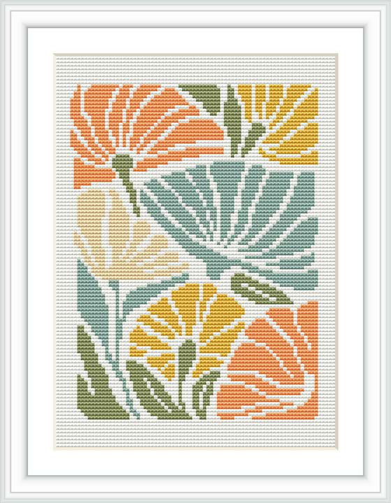 A framed cross stitch pattern featuring stylized floral motifs in a bohemian style. The design is composed of mustard yellow, coral, and sage green colors on an ivory background, placed within a simple white frame.