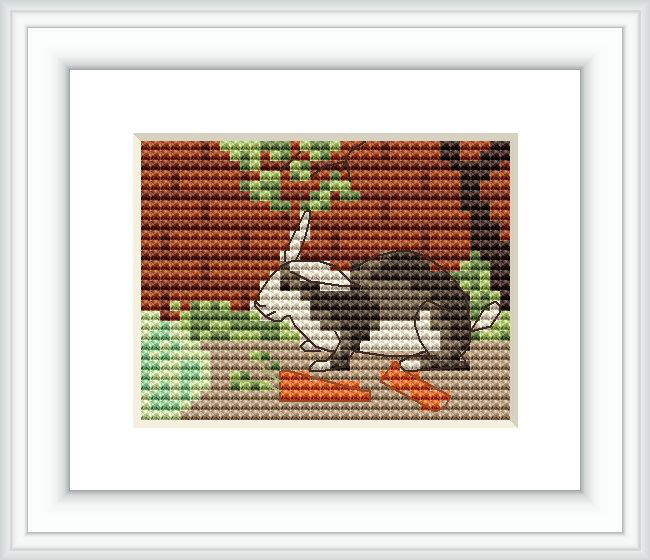 The image shows a cross stitch pattern of a rabbit in profile, positioned centrally on the canvas. Surrounding the rabbit are indicative shapes of plants and the ground, created using various earthy colored threads.