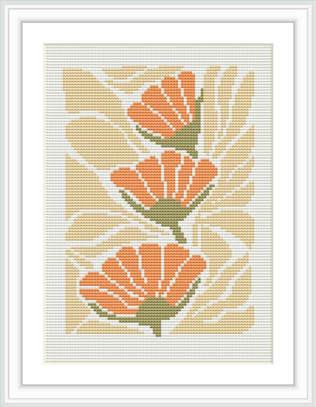 The image features a cross stitch pattern with stylized orange flowers against a cream-colored background. The stitched piece is framed with a white border within a larger frame.