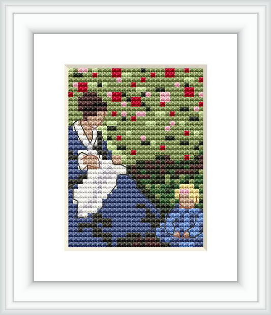 The cross stitch pattern depicts a woman, possibly a mother, sitting with a child in a lush garden environment. It appears they are surrounded by flowering plants, with the overall scene conveying a peaceful domestic moment.