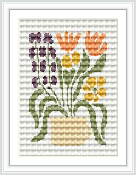 The image displays a cross stitch pattern showing a flowerpot with a collection of flowers in different colors such as purple, orange, and yellow. The pot is centered in the composition and is surrounded by greenery.