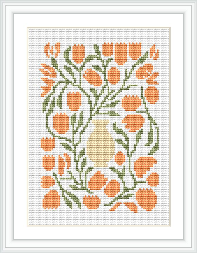 The image shows a cross stitch pattern of a cream-colored vase with a bouquet of orange tulips surrounded by green foliage, encased within a white border and framed.