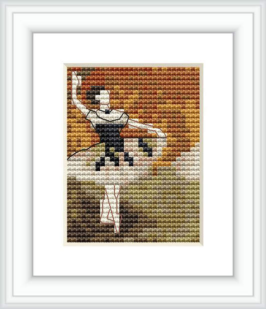 The image displays a framed cross stitch pattern depicting a ballet dancer with a tambourine. The dancer is in a dynamic pose and set against a backdrop of warm-toned impressionistic pixelation.