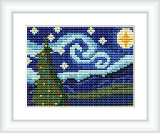 The image depicts a framed cross stitch pattern showcasing a Christmas tree on a starry night with swirl patterns in the sky and a crescent moon.