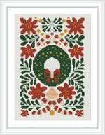 The cross stitch design features a central green wreath with a pair of red mittens. It's surrounded by symmetrical patterns of red poinsettias and pine branches, some with yellow and gold berries and ornaments. The backdrop is white.