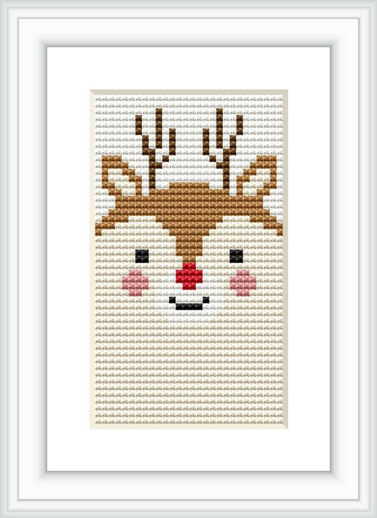 The image displays a framed cross stitch pattern of a stylized deer face with antlers. The design is centered on a light background fabric, positioned within a minimalist white frame.