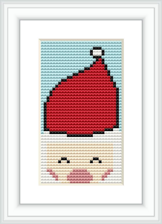 The image depicts a framed cross stitch pattern resembling Santa Claus' red hat with a white trim, positioned against a sky blue background with a small visible grid akin to aida cloth. The pattern is compactly contained within a rectangular frame.