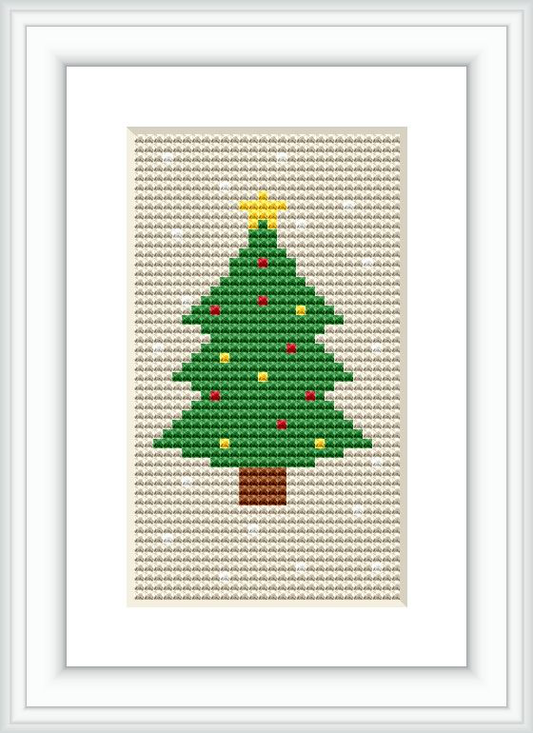 The image shows a framed cross stitch pattern of a Christmas tree with colorful ornaments and a yellow star on top, set against an off-white canvas background.