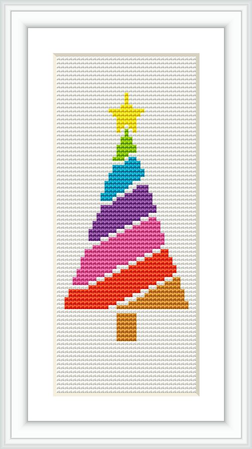 The image displays a framed cross stitch pattern of a multicolored Christmas tree displayed vertically, with a star on top, set against a white canvas-like background.