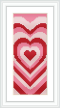 The image showcases a framed cross stitch piece of a heart-themed bookmark with a gradient of reds and pinks against a white background.