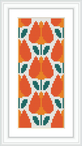 The image displays a framed cross stitch pattern featuring a symmetrical floral design in a vertical rectangular format, predominantly in orange and white with green accents.