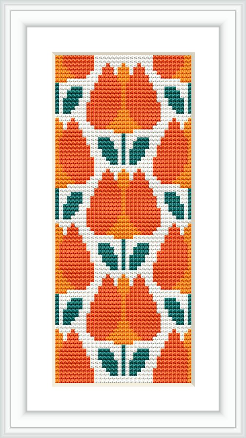 The image displays a framed cross stitch pattern featuring a symmetrical floral design in a vertical rectangular format, predominantly in orange and white with green accents.