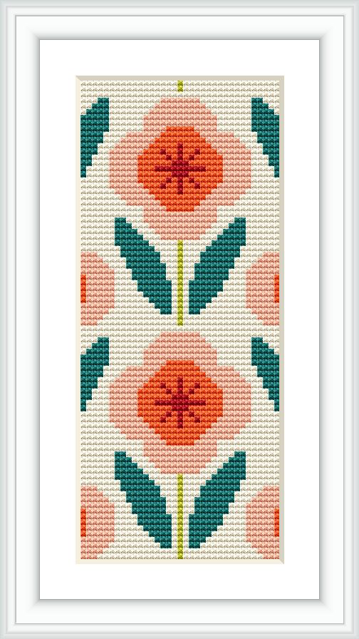 The image presents a framed cross stitch pattern featuring a symmetrical arrangement of stylized flowers with a geometric border, primarily in peach and green tones against a cream background.