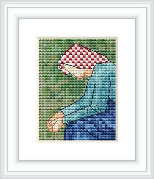 The image depicts a framed cross stitch pattern showing a seated peasant woman. She is wearing a checkered headscarf and a blue top, with a greenish background to represent the countryside.