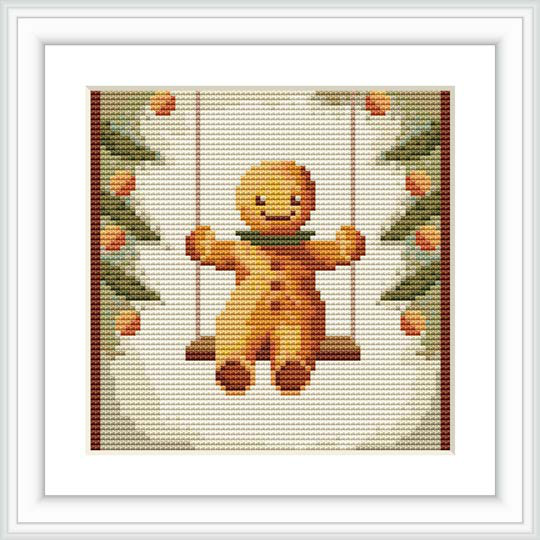 The image showcases a cross stitch pattern framed in a square format. The pattern features a gingerbread man in the center, sitting on a swing, with a festive garland of holly leaves and berries bordering the design.