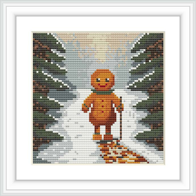 The image depicts a gingerbread man centered in a cross stitch pattern, flanked by two rows of fir trees against a wintery backdrop, creating the appearance of a snowy trail behind him.