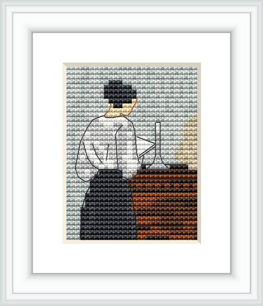 The cross stitch design depicts a woman from behind, looking at a tall object on a wooden surface, surrounded by a neutral color palette.